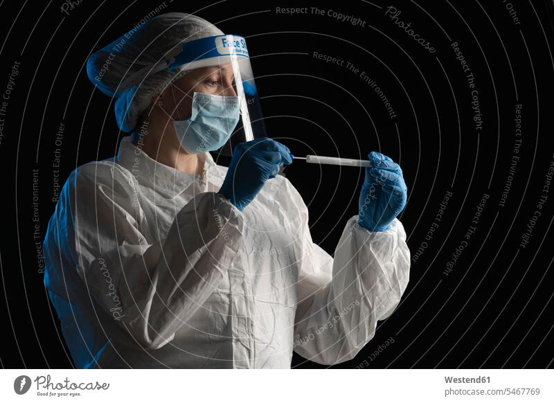 Woman in protective wear putting a swab into a tube (value=0) Occupation Work job jobs profession professional occupation At Work hold health healthcare
