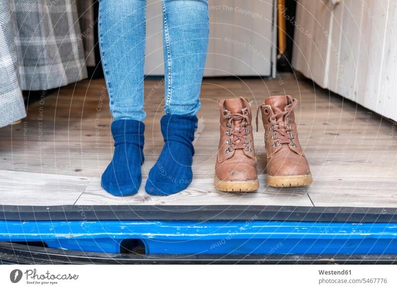 Female feet and boots at the door of a camper van color image colour image outdoors location shots outdoor shot outdoor shots day daylight shot daylight shots