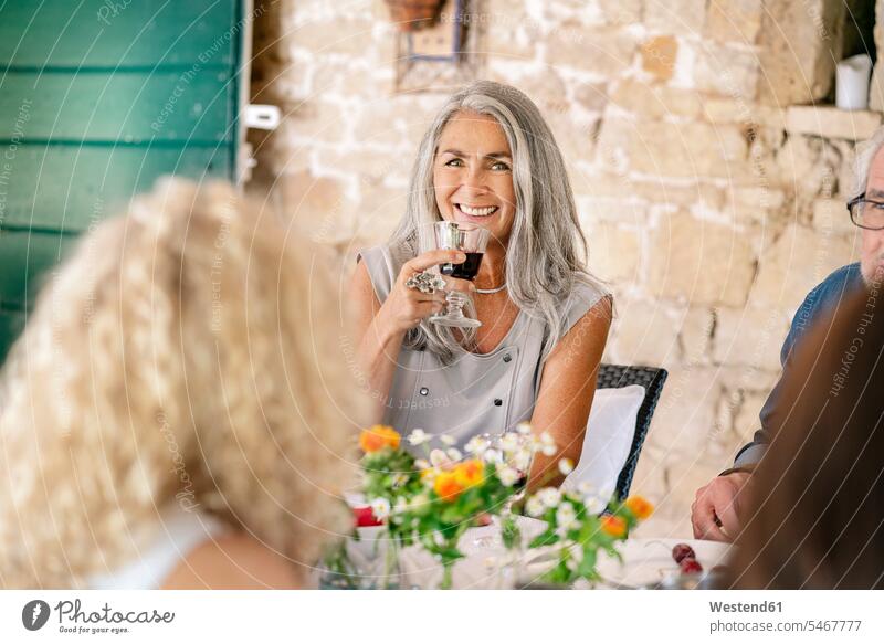 Portrait of smiling woman drinking wine on a family celebration females women Family Celebration Family Parties Family Celebrations Family Party Red Wine