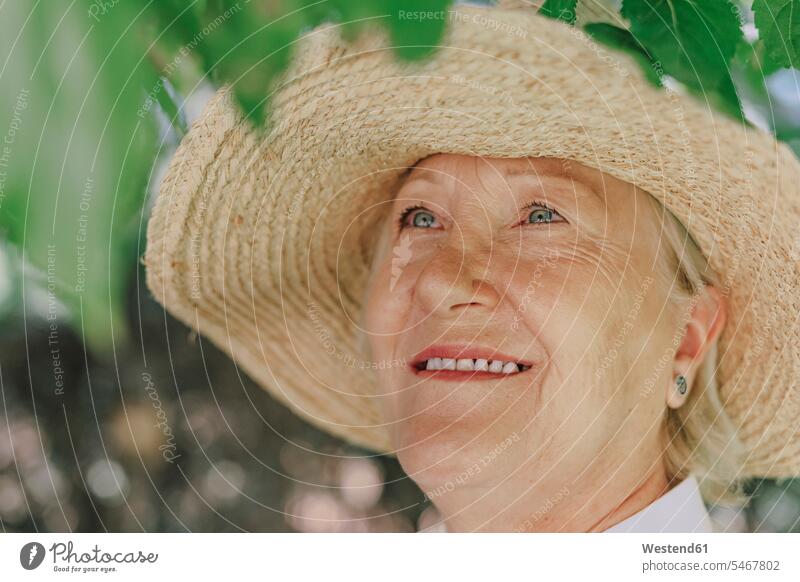 Close-up of smiling senior woman wearing hat looking up color image colour image Spain leisure activity leisure activities free time leisure time outdoors