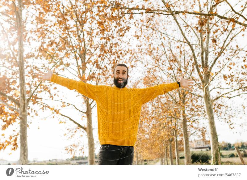Young man with open arms and happy in a park in autumn morning in the morning Joy enjoyment pleasure Pleasant delight father fathers daddy dads papa open-minded