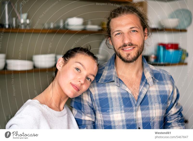 Portrait of a happy young couple at home confidence confident portrait portraits young couples young twosome young twosomes happiness adult couple adult couples