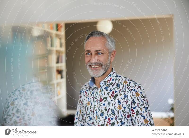 Portrait of smiling mature man wearing patterned shirt at home human human being human beings humans person persons celibate celibates singles solitary people