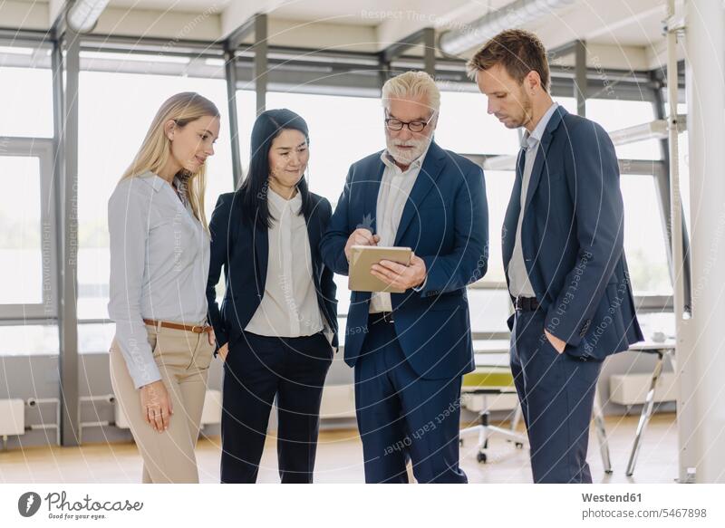 Business people with tablet having a meeting in office human human being human beings humans person persons caucasian appearance caucasian ethnicity european