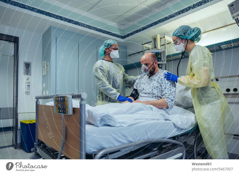 Doctors giving artificial respiration to patient in emergency care unit of a hospital colleague health healthcare Healthcare And Medicines medical medicine
