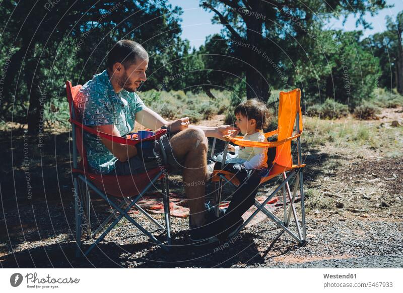 USA, Arizona, Grand Canyon National Park, father and daughter eating outdoors pa fathers daddy dads papa baby infants nurselings babies daughters parents family