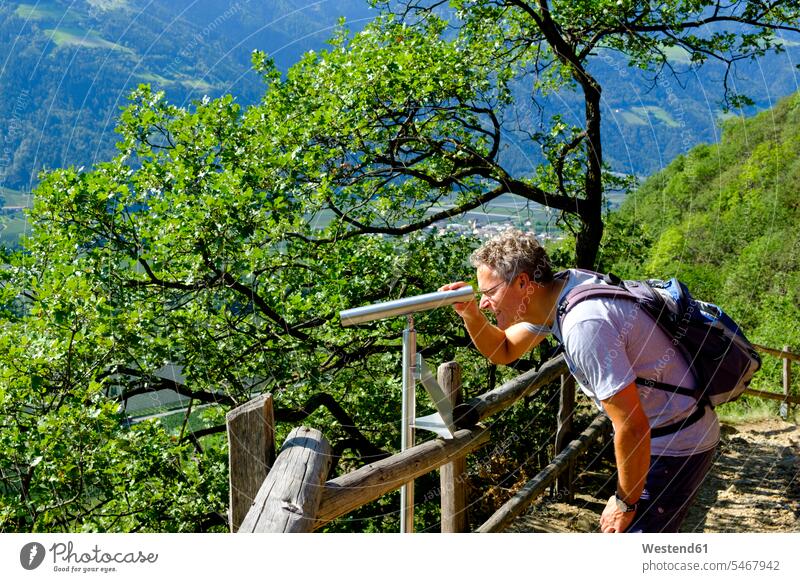 Italy, South Tyrol, Vinschgau, Naturns, Sonnenberg Panorama Trail, hiker looking through telescope hiking tour walking tour leisure free time leisure time
