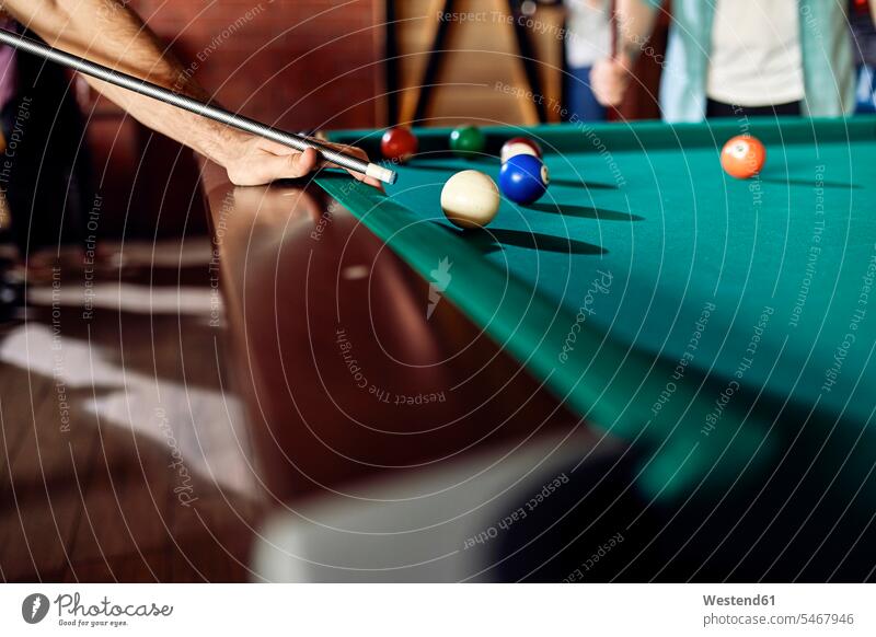Close-up of man playing billiards men males friends mate Adults grown-ups grownups adult people persons human being humans human beings game games friendship