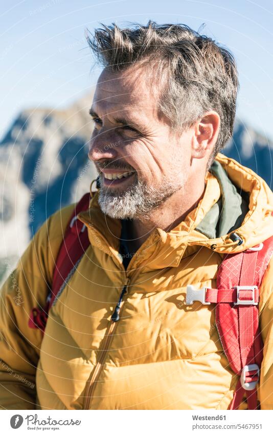 Austria, Tyrol, portrait of smiling man on a hiking trip in the mountains happiness happy hiking tour walking tour mountain range mountain ranges men males