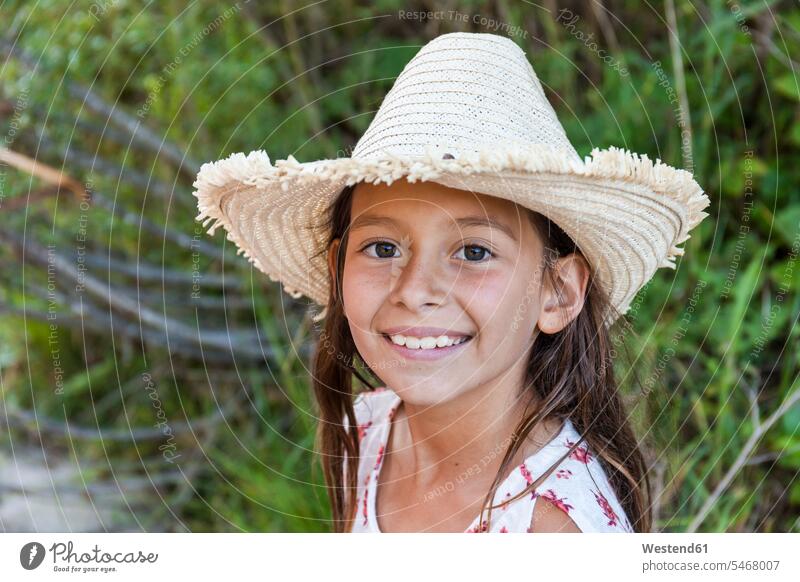 Portrait of smiling girl wearing straw hat outdoors smile females girls straw hats portrait portraits child children kid kids people persons human being humans