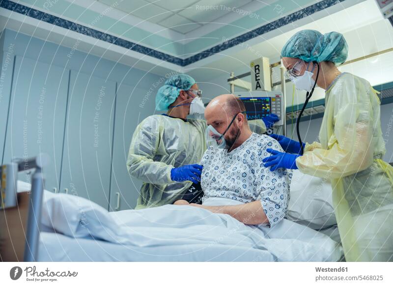 Doctors giving artificial respiration to patient in emergency care unit of a hospital colleague health healthcare Healthcare And Medicines medical medicine