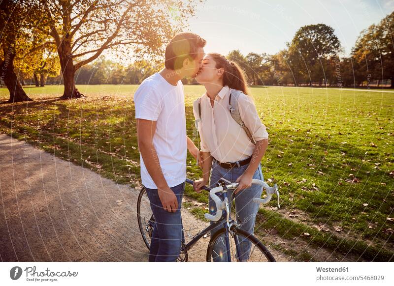 Young couple in love kissing in a park parks twosomes partnership couples kisses people persons human being humans human beings Germany copy space relationship