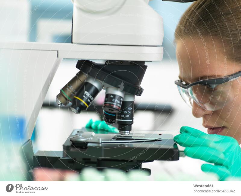 Health Screening, Scientist holding a tube containing a blood sample ready for analysis in the laboratory object plate microscope plate Microscope Slide