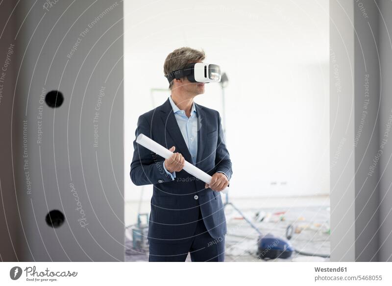 Man in suit wearing VR glasses in building under construction man men males buildings construction site Building Site sites Building Sites construction sites