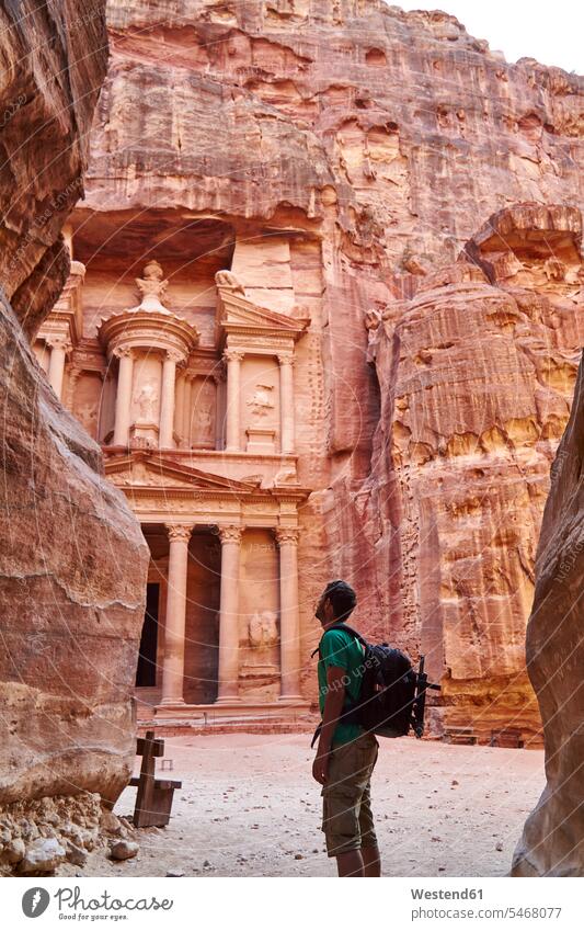 Backpacker admiring the Al-Khazneh in Petra, Jordan touristic tourists back-pack back-packs backpacks rucksack rucksacks The Past stand place of interest sight