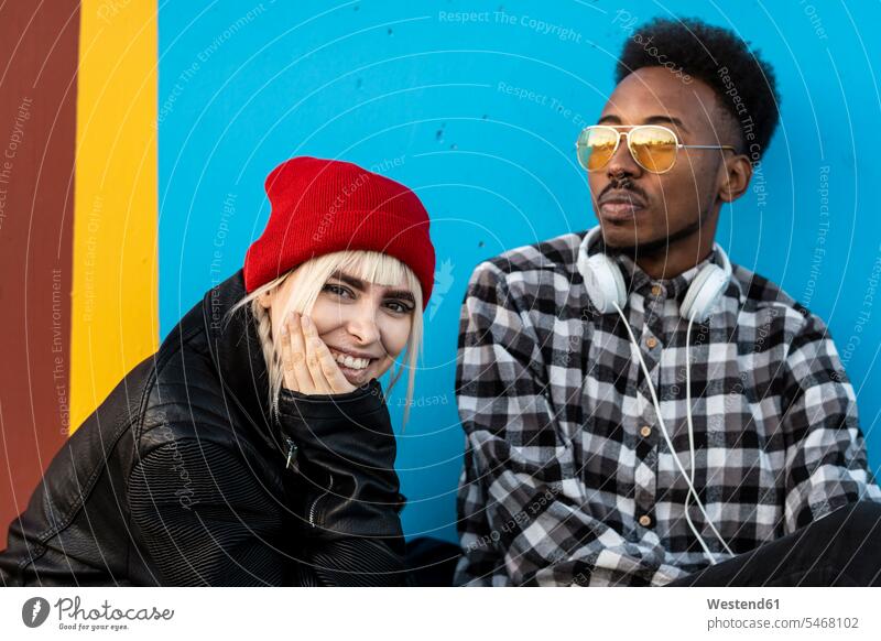 Portrait of young couple against blue wall human human being human beings humans person persons caucasian appearance caucasian ethnicity european African black
