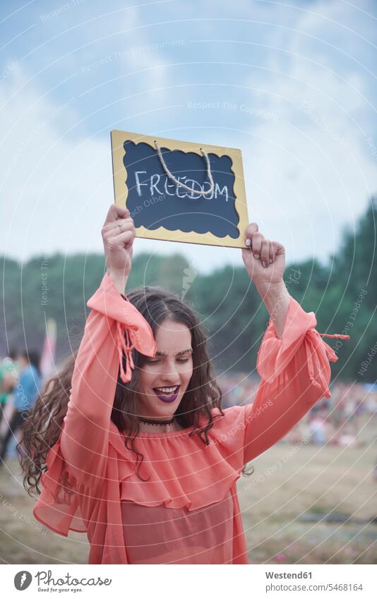 Woman holding sign at music festival, freedom smiling smile signs Holding Aloft Freedom Liberty music festivals happiness happy Peace peacefulness Festival