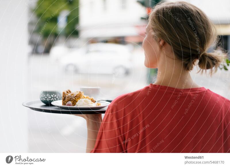 Rear viewof young woman serving coffee and cake in a cafe Coffee serve pies cakes females women Drink beverages Drinks Beverage food and drink Nutrition