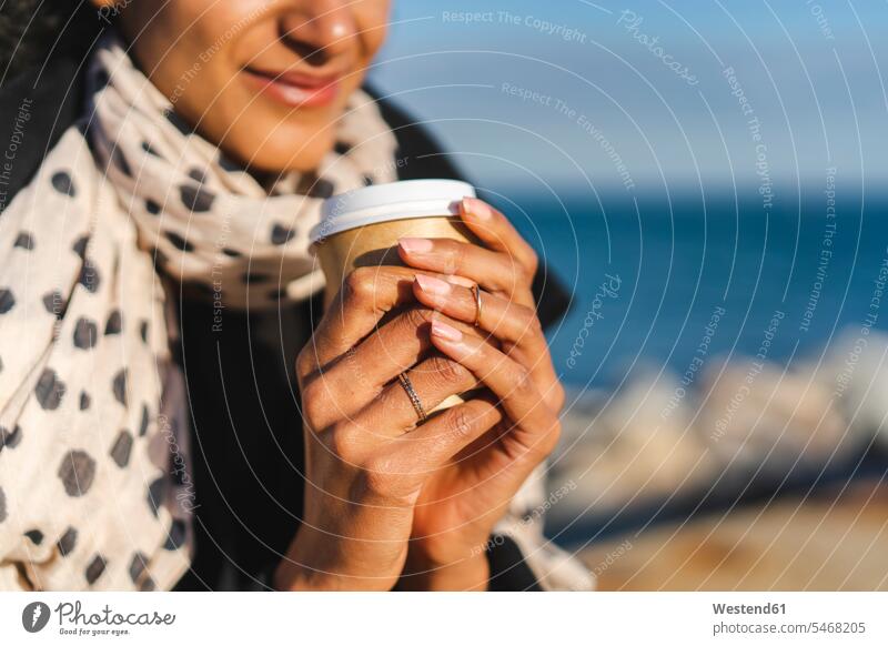 Woman's hands holding coffee to go, close-up human hand human hands Coffee woman females women people persons human being humans human beings Drink beverages