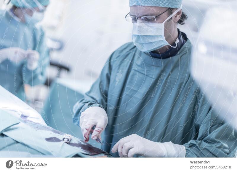 Neuroradiologist in scrubs during an operation doctor physicians doctors hospital Medical Clinic surgical gown Operating Gown surgery surgeries operating