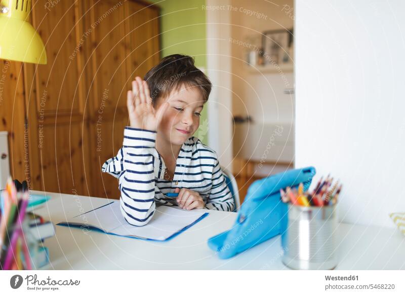 Boy doing homeschooling and using tablet at home human human being human beings humans person persons caucasian appearance caucasian ethnicity european 1