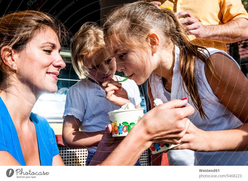 Family having ice cream at an ice cream parlor human human being human beings humans person persons Mixed Race mixed race ethnicity mixed-race Person