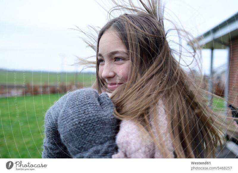 Portrait of smiling girl with blowing hair in winter females girls portrait portraits hibernal smile child children kid kids people persons human being humans