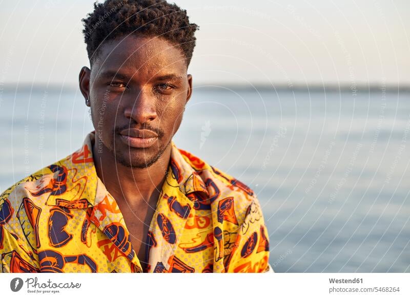 Young man standing at the sea, portrait human human being human beings humans person persons African black black ethnicity coloured 1 one person only