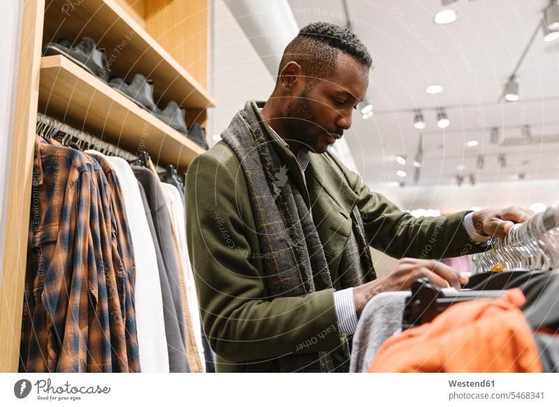 Stylish man shopping in a clothes store human human being human beings humans person persons client clientele clients customers business life business world