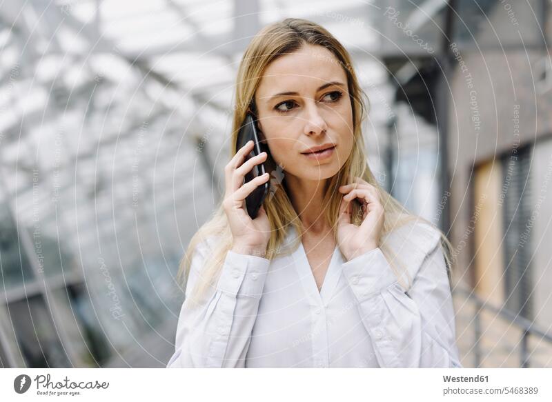 Portrait of a serious young businesswoman on the phone Occupation Work job jobs profession professional occupation business life business world business person