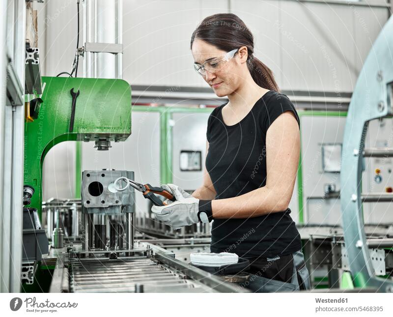 Young woman working on a machine Austria worker female workers metalworking metal fabrication metal working metal processing Competence Skill metal construction