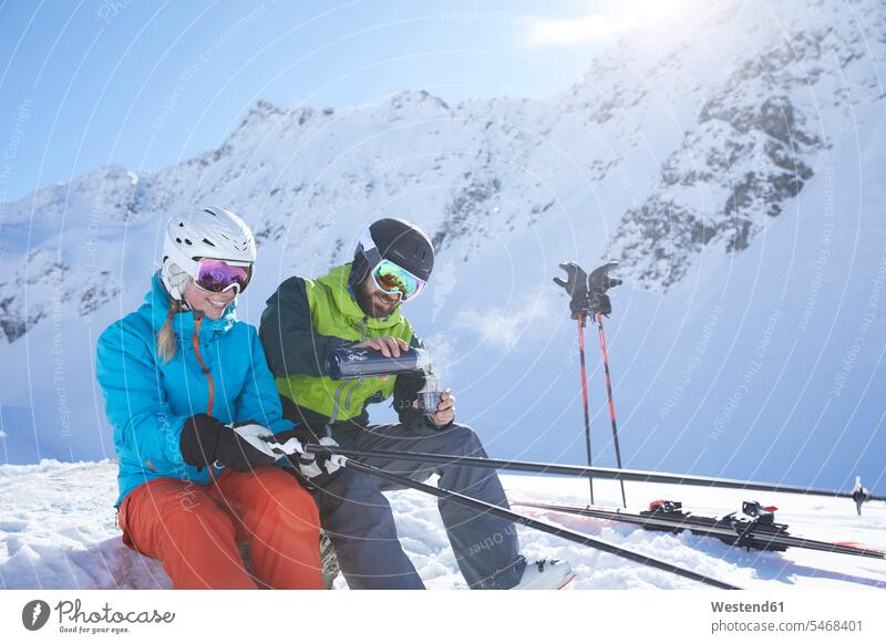 Austria, Tyrol, Kuehtai, two skiers in winter landscape having a break winter landscapes scenery terrain hibernal couple twosomes partnership couples people