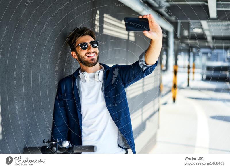 Portrait of smiling man taking selfie with smartphone smile Smartphone iPhone Smartphones Selfie Selfies portrait portraits men males mobile phone mobiles