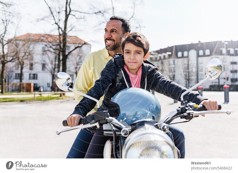 Father and son on a motorbike Motor Cycle happiness happy father pa fathers daddy dads papa sons manchild manchildren motor vehicle road vehicle road vehicles