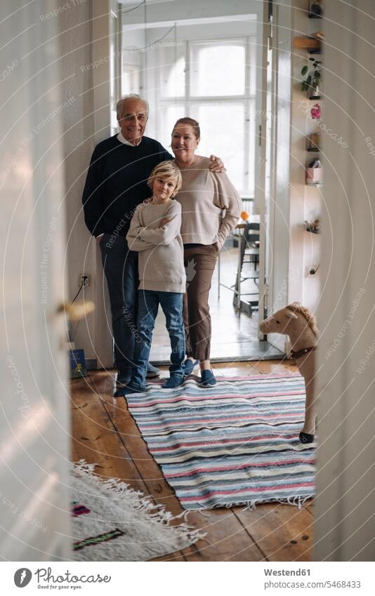 Portrait of happy grandparents with grandson at home generation jumper sweater Sweaters smile embrace Embracement hug hugging delight enjoyment Pleasant