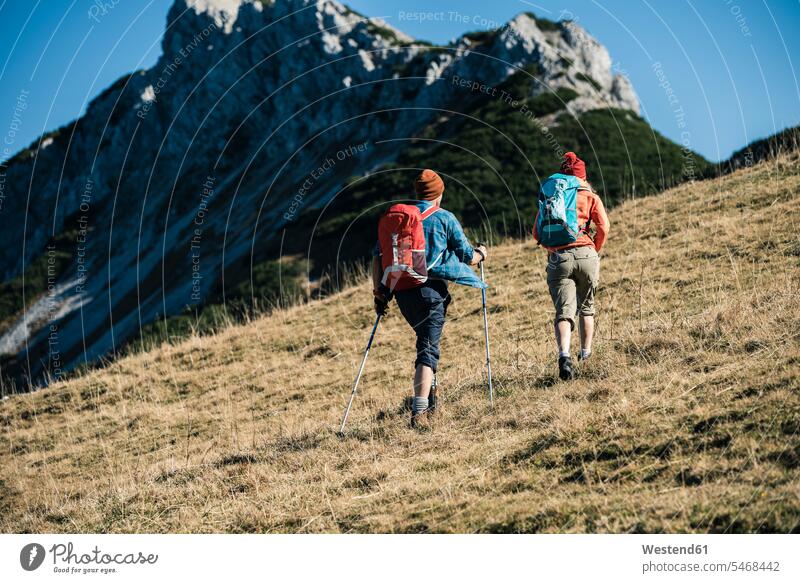 Austria, Tyrol, couple hiking in the mountains hike twosomes partnership couples mountain range mountain ranges mountainscape mountainscapes mountain scenery