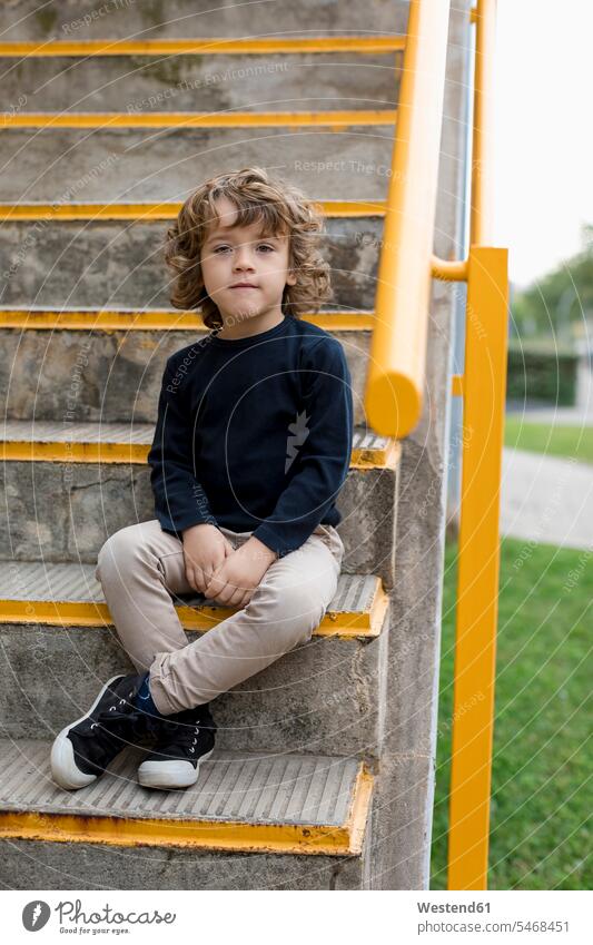 Portrait of boy sitting on stairs stairway Seated boys males portrait portraits child children kid kids people persons human being humans human beings