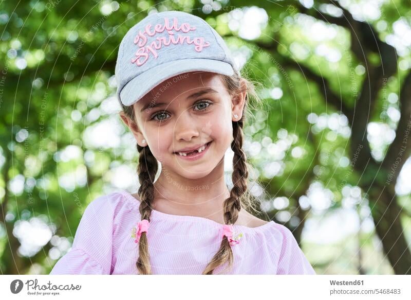 Portrait of little girl with green eyes braids and cap, smiling brown hair brown haired brown-haired brunette smile leisure free time leisure time content