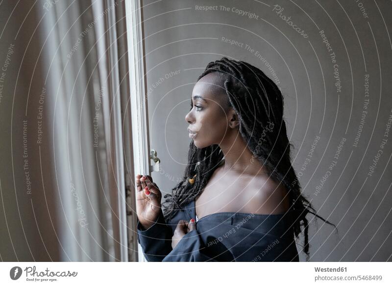 Profile of woman with dreadlocks looking out of window windows view seeing viewing females women profile Profile View profiles hairstyle hair-dos hairstyles
