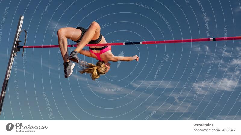 Female high jumper, worm's eye view jumping Leaping jumps athlete sportswoman athletes female athlete sportswomen female athletes high jumping