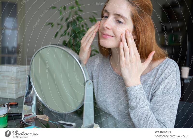 Young woman applying facial cream at home human human being human beings humans person persons caucasian appearance caucasian ethnicity european 1