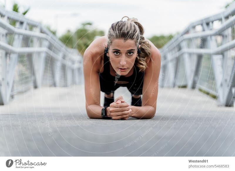 Sporty woman with headphones, working out on a bridge human human being human beings humans person persons caucasian appearance caucasian ethnicity european