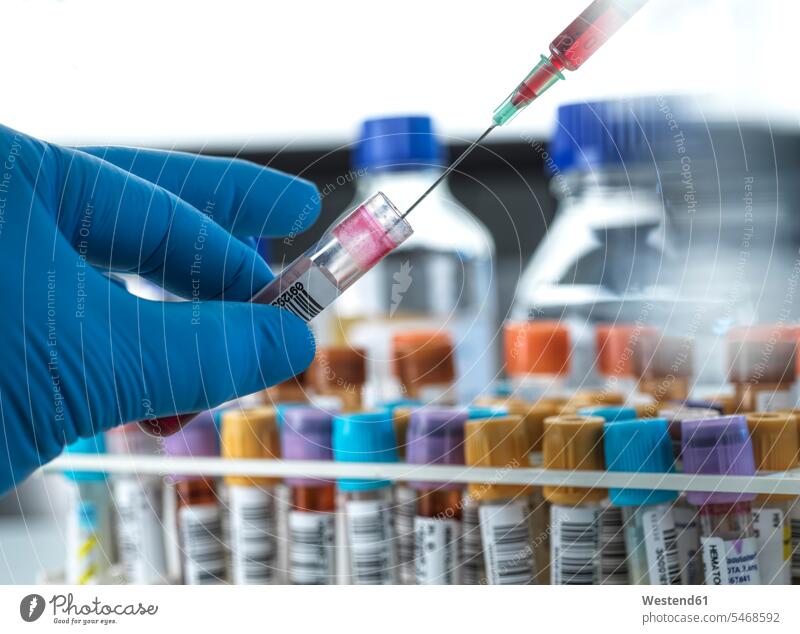 Biomedical technician working with blood sample at laboratory color image colour image scientist science scientific sciences indoors indoor shot indoor shots