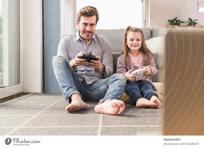 Young man and little girl playing computer game with gaming console Competition competitive single parent hand control hand operation manual control games
