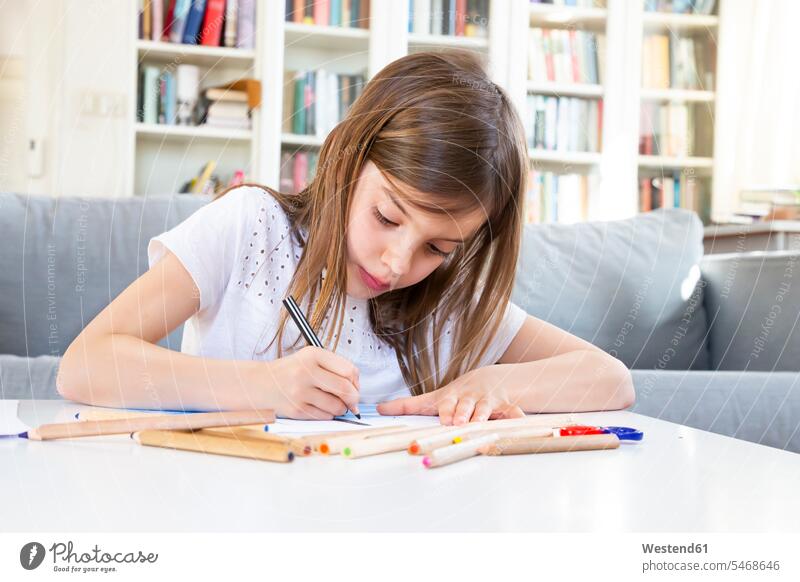 Portrait of girl drawing with coloured pencil at home images picture pictures drawings Child's Drawings children's drawing Childs Drawing couches settee settees