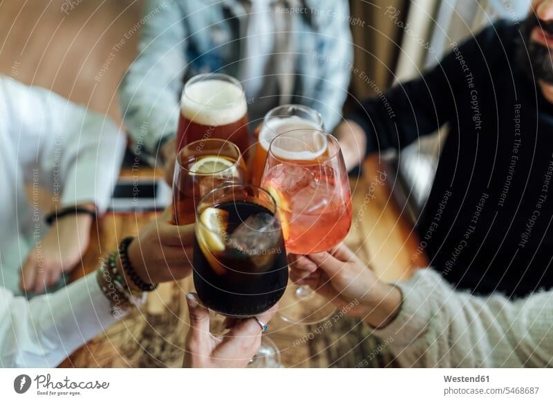 Friends hands toasting glasses at bar color image colour image indoors indoor shot indoor shots interior interior view Interiors 16-17 years 16 to 17 years
