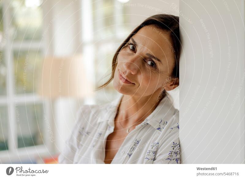 Portrait of mature woman leaning against doorframe portraits human human being human beings humans person persons adult grown-up grown-ups grownup grownups