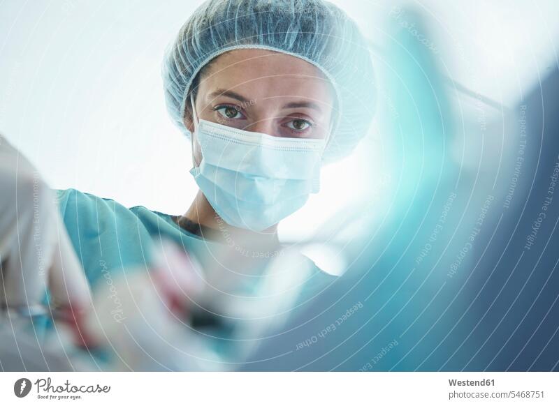 Confident female surgeon operating in intensive care unit at hospital color image colour image South Africa indoors indoor shot indoor shots interior