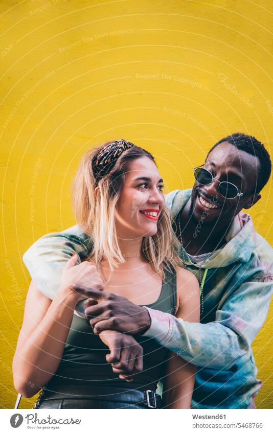 Portrait of happy couple in front of yellow wall human human being human beings humans person persons African black black ethnicity coloured