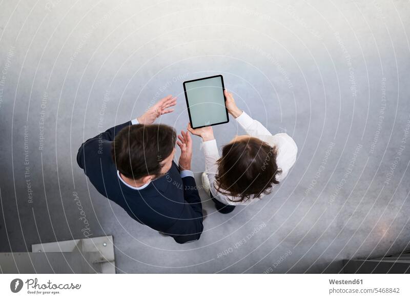 Top view of businessman and woman with tablet talking in a factory human human being human beings humans person persons caucasian appearance caucasian ethnicity